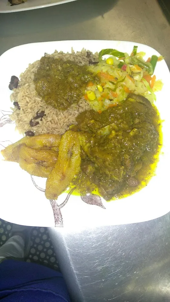 Curry Goat Steamed Veggies Rice and Peas